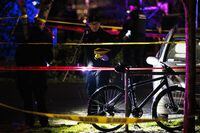 A police officer views the crime scene, where according to the Portland Police Bureau one person was shot dead and five others were wounded, at Normandale Park in Portland, Oregon, U.S., February 19, 2022. Picture taken February 19, 2022. REUTERS/Mathieu Lewis-Rolland