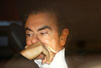 FILE PHOTO: Former Nissan Motor Chairman Carlos Ghosn sits inside a car as he leaves his lawyer's office after being released on bail from Tokyo Detention House, in Tokyo, Japan, March 6, 2019. REUTERS/Issei Kato/File Photo