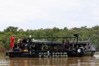 Police officers and rescue team members stand on a boat during the search operation for British journalist Dom Phillips and indigenous expert Bruno Pereira, who went missing while reporting in a remote and lawless part of the Amazon rainforest, near the border with Peru, in Atalaia do Norte, Amazonas state, Brazil, June 12, 2022.REUTERS/Bruno Kelly