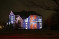 A projection showing support for Buffalo Bills safety Damar Hamlin is seen on Michael and Shauna Karas' house Friday, Jan. 6, 2023, in Lancaster, N.Y. Hamlin is now breathing and walking on his own, and traded in the writing pad he had been using to communicate. (AP Photo/Joshua Bessex)