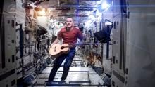 An undated image from NASA TV shows the astronaut Chris Hadfield performing his rendition of David Bowie’s “A Space Oddity” aboard the International Space Station in 2013. For two decades, the space station has been humanity’s home in space, about 240 miles above the Earth. (NASA TV via The New York Times) — FOR EDITORIAL USE ONLY —