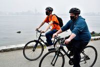 FILE PHOTO: Cyclists wear masks in Stanley Park in Vancouver, British Columbia, Canada September 14, 2020. REUTERS/Jennifer Gauthier/File Photo