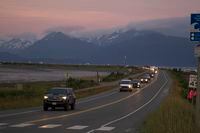 A line of cars evacuates the Homer Spit in Homer, Alaska on July 28, 2021, after a tsunami warning was issued following a magnitude 8.2 earthquake. The tsunami warning for much of Alaska's southern coast was canceled when the biggest wave, of just over a half foot, was recorded in Old Harbor. Alaska. (Sarah Knapp/Homer News via AP)