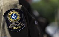 Over a dozen people suffered minor injuries and some were taken to hospital after a footbridge collapsed at an event to celebrate a mountain bike World Cup event northeast of Quebec City on Saturday. A&nbsp;Surete du Quebec emblem is seen on an officer’s uniform in Montreal, Tuesday, Aug. 22, 2023. THE CANADIAN PRESS/Christinne Muschi