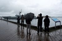 Onlookers watch as the Irish Patrol vessel LE James Joyce sails away from the Halifax Waterfront to seek shelter before the arrival of Hurricane Fiona in Halifax, Nova Scotia, Canada September 23, 2022.  REUTERS/Ingrid Bulmer