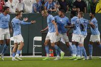 Manchester City's Jack Grealish and Erling Haaland celebrate after a goal against Bayern Munich during the first half of a friendly soccer match Saturday, July 23, 2022, at Lambeau Field in Green Bay, Wis. (AP Photo/Morry Gash)