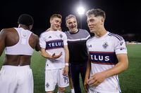 Vancouver Whitecaps coach Vanni Sartini celebrates with Julian Gressel, second left, and Sebastian Berhalter, right, after their victory over York United FC in the Canadian Championship quarterfinal soccer game in Toronto on Wednesday, May 10, 2023. THE CANADIAN PRESS/Cole Burston