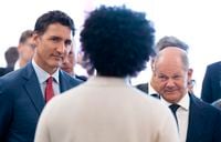 Prime Minister Justin Trudeau and German Chancellor Olaf Scholz meet with a researcher at Mila, a Quebec Artificial Intelligence Institute, in Montreal on Aug. 22, 2022.