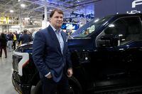 FILE PHOTO: Ford CEO Jim Farley poses next to a model of the all-new Ford F-150 Lightning electric pickup truck at the Ford Rouge Electric Vehicle Center in Dearborn, Michigan, U.S. April 26, 2022. REUTERS/Rebecca Cook/File Photo