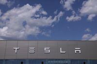 GRUENHEIDE, GERMANY - JULY 17: The Tesla logo adorns the facade of a building at the Tesla factory on July 17, 2023 near Gruenheide, Germany. Tesla will reportedly present its plans tomorrow to expand production at the factory, from thee current level of approximately 250,000 cars per year to one million. The plan calls for the construction of a new assembly hall that will be the size of 60 soccer fields, which is likely to draw opposition from local communities.  (Photo by Sean Gallup/Getty Images)