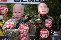 Anti-war activists wearing masks of U.S President Joe Biden and South Korea's President Yoon Suk-yeol hold a protest against joint U.S.-South Korea military exercises on the occasion of U.S. House of Representatives Speaker Nancy Pelosi's visit, in front of the Presidential Office in Seoul, South Korea, August 4, 2022. REUTERS/Kim Hong-Ji