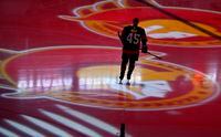 FILE - Ottawa Senators left wing Parker Kelly skates as projections of the team's logo spin on the ice before the team's NHL hockey game against the Boston Bruins on Tuesday, Oct. 18, 2022, in Ottawa, Ontario. A group led by Canadian businessman Michael Andlauer has reached an agreement to buy the NHL’s Ottawa Senators. The team announced Tuesday, June 13, 2023, that Andlauer and his group will purchase 90% of the club from the Melnyk family. (Justin Tang/The Canadian Press via AP, File)