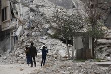 People stans by a building destroyed in recent earthquake in Aleppo, Syria, Monday, Feb. 27, 2023. (AP Photo/Omar Sanadiki)