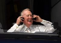 FILE - In this Monday, Sept. 19, 2016, file photo, Los Angeles Dodgers' Hall of Fame announcer Vin Scully puts his headset on prior to a baseball game between the Los Angeles Dodgers and the San Francisco Giants in Los Angeles.   Scully, whose dulcet tones provided the soundtrack of summer while entertaining and informing Dodgers fans in Brooklyn and Los Angeles for 67 years, died Tuesday night, Aug. 2, 2022, the team said. He was 94.  (AP Photo/Mark J. Terrill, File)