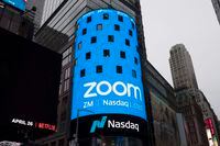 FILE - This April 18, 2019, file photo shows a sign for Zoom Video Communications ahead of the company's Nasdaq IPO in New York. Zoom’s astronomical growth is tapering off along with the pandemic. That's raising questions about whether the videoconferencing service’s immense popularity will fade as more people return to classrooms, offices and other places off limits for the past year. The deceleration emerged in an otherwise impressive quarterly earnings report released Monday, March 1, 2021. (AP Photo/Mark Lennihan, File)