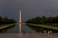 The Washington Monument stands below a dark sky in Washington on Monday, Aug. 7, 2023. Strong thunderstorms from Georgia to New York on Monday caused nearly one million homes and businesses to lose power, and at least eight states are under tornado watch. (Jason Andrew/The New York Times)