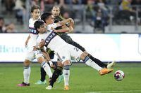Los Angeles FC defender Denil Maldonado, center, defends against Vancouver Whitecaps forward Brian White (24) during the second half of an MLS soccer match in Los Angeles, Saturday, June 24, 2023. (AP Photo/Ashley Landis)