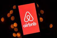 (FILES) In this file illustration picture taken on November 22, 2019, shows the logo of the online lodging service Airbnb displayed on a smartphone in Paris. - Airbnb said August 2, 2022 revenue in the recently ended quarter topped $2 billion as people shook off pandemic worries and took part in a banner travel season. (Photo by Lionel BONAVENTURE / AFP) (Photo by LIONEL BONAVENTURE/AFP via Getty Images)