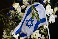 A photo taken on August 17, 2022 shows a wreath with an Israeli flag at the memorial site 'Erinnerungsort Olympia-Attentat' (Place of remembrance of the Olympic attack) at the Olympic Park in Munich, southern Germany. - On September 5, 1972, eight gunmen of the Palestinian militant group Black September broke into the Israeli team's flat at the Olympic Village in Munich, shooting dead two and taking nine Israelis hostage. West German police responded with a bungled rescue operation in which all nine hostages were killed, along with five of the eight hostage-takers and a German police officer. The Games were meant to showcase a new Germany 27 years after the Holocaust but instead opened a deep rift with Israel. (Photo by INA FASSBENDER / AFP) (Photo by INA FASSBENDER/AFP via Getty Images)