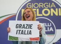 Far-Right party Brothers of Italy's leader Giorgia Meloni shows a placard reading in Italian "Thank you Italy" at her party's electoral headquarters in Rome, Monday, Sept. 26, 2022.The Brothers of Italy party, the biggest vote-getter in Italy's national election, has its roots in the post-World War II neofascist Italian Social Movement and proudly kept its symbol the tricolor flame as the visible and symbolic proof of its inheritance as it went from a fringe far-right group to the biggest party in Italian politics. (AP Photo/Gregorio Borgia)