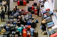 Luggage bags are amassed in the bag claim area at Toronto Pearson International Airport, as a major winter storm disrupts flights in and out of the airport, in Toronto, Saturday, Dec. 24, 2022. Cole Burston/THE CANADIAN PRESS