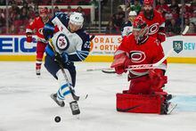Mar 14, 2023; Raleigh, North Carolina, USA;  Winnipeg Jets right wing Nino Niederreiter (62) goes for the rebound against Carolina Hurricanes goaltender Frederik Andersen (31) during the second period at PNC Arena. Mandatory Credit: James Guillory-USA TODAY Sports
