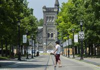 A person walks past the University of Toronto campus during the COVID-19 pandemic in Toronto, Wednesday, June 10, 2020.&nbsp;The University of Toronto says it will sell off all fossil fuel investments in its $4 billion endowment by the end of 2030 and target a net-zero portfolio by 2050 to help fight climate change. THE CANADIAN PRESS/Nathan Denette