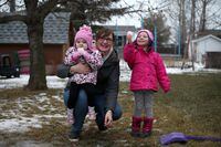 Two-year-old Hallie Thiessen with her mother, Cari-Lynn Thiessen and older sister Addison at their home in Steinbach, Manitoba on December 10, 2020. Hallie has been diagnosed with a rare form of Eosinophilic Gastrointestinal Disease and requires a feeding tube. SHANNON VANRAES / THE GLOBE AND MAIL