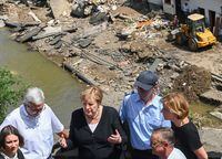 German Chancellor Angela Merkel (2nd L) and Rhineland-Palatinate State Premier Malu Dreyer (R) talk as they stand on a bridge during their visit in the flood-ravaged areas in Schuld near Bad Neuenahr-Ahrweiler, Rhineland-Palatinate state, Germany July 18, 2021. Christof Stache/Pool via REUTERS