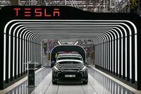FILE PHOTO: Model Y cars are pictured during the opening ceremony of the new Tesla Gigafactory for electric cars in Gruenheide, Germany, March 22, 2022. Patrick Pleul/Pool via REUTERS/File Photo