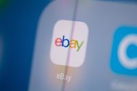 (FILES) In this file photo illustration taken on July 24, 2019 in Paris shows the logo of the US web auctions application Ebay on the screen of a tablet. - Struggling online retail giant eBay named a new top executive on April 13, 2020, bringing in the former head of e-commerce at Walmart, Jamie Iannone. Iannone will take over April 27 from interim CEO Scott Schenkel, who took over after Devin Wenig stepped down last year. Most recently Iannone was chief operating officer of Walmart eCommerce and has some 20 years of experience in retail and digital operations, according to an eBay statement. (Photo by Martin BUREAU / AFP) (Photo by MARTIN BUREAU/AFP via Getty Images)