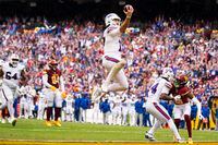 Buffalo Bills quarterback Josh Allen (17) leaps into the end zone to score a touchdown against the Washington Commanders during the second half of an NFL football game, Sunday, Sept. 24, 2023, in Landover, Md. (AP Photo/Evan Vucci)