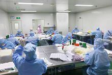 Workers work on manufacturing antigen testing kits for the coronavirus disease (COVID-19), at a workshop in Nantong, Jiangsu province, China December 19, 2022. China Daily via REUTERS ATTENTION EDITORS - THIS IMAGE WAS PROVIDED BY A THIRD PARTY. CHINA OUT.