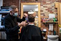 Business owner and barber, Joseph Polsoni sees customer Tyler Mathies, on the last day he his able to open before a mandatory 28 day shut-down of his business, in Toronto, on Sunday, Nov., 22, 2020  (Christopher Katsarov/The Globe and Mail)