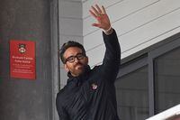 US actor and Wrexham owner Ryan Reynolds waves to fans ahead of the English National League football match between Wrexham and Boreham Wood at the Racecourse Ground Stadium in Wrexham, north Wales, on April 22, 2023. (Photo by Oli SCARFF / AFP) (Photo by OLI SCARFF/AFP via Getty Images)