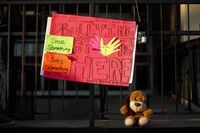 A sign and stuffed animal lay at the entrance to Sir Winston Churchill Secondary School ahead of a vigil for murdered 14-year-old Devan Selvey, at his high school, in Hamilton, Ont., Wednesday, Oct. 9, 2019. Hearing about the stabbing death of a 14-year-old boy outside a school in Hamilton has Darrel Crimeni grappling with questions of bullying and a lack of empathy that may also have played a role when his grandson's overdose was filmed and posted on social media. THE CANADIAN PRESS/ Cole Burston