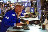 Traders work on the floor at the New York Stock Exchange in New York, Tuesday, June 14, 2022. Wall Street is wobbling between gains and losses Tuesday in its first trading after tumbling into a bear market on worries about a fragile economy and rising rates. (AP Photo/Seth Wenig)