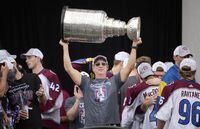 Colorado Avalanche general manager Joe Sakic lifts the Stanley Cup during a rally outside the City/County Building for the NHL hockey champions after a parade through the streets of downtown Denver, Thursday, June 30, 2022. (AP Photo/David Zalubowski)