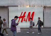 BEIJING, CHINA - MARCH 25: People walk by the flagship store of clothing brand H&M at a shopping area on March 25, 2021 in Beijing, China. Chinese state media and social networking platforms called for boycotts of major Western brands, including H&M, after statements made by the companies in the past about Xinjiang cotton resurfaced online. (Photo by Kevin Frayer/Getty Images)