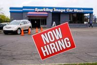 A help-wanted sign is displayed at a car wash in Indianapolis on Sept. 2, 2020.