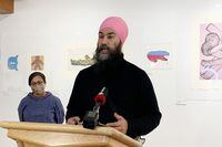 Federal NDP Leader Jagmeet Singh speaks as Nunavut NDP MP Lori Idout looks on at a news conference in Iqaluit, Nunavut, on Tuesday, Nov. 16, 2021. Singh wants the Liberal government to pay the cost of fixing Iqaluit's ongoing water emergency. Some 8,000 people who live in Nunavut's capital haven't been able to drink their tap water since Oct. 12 when it was found to contain fuel. THE CANADIAN PRESS/Emma Tranter