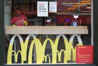FILE PHOTO: A worker disinfects a McDonald's restaurant, following the coronavirus disease (COVID-19) outbreak, in Leicester, Britain, June 30, 2020. REUTERS/Molly Darlington