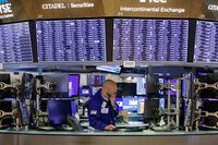 FILE PHOTO: A trader works on the trading floor at the New York Stock Exchange (NYSE) in Manhattan, New York City, U.S., August 9, 2021. REUTERS/Andrew Kelly