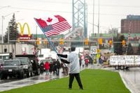 Truckers and supporters block the access leading from the Ambassador Bridge, linking Detroit and Windsor, as truckers and their supporters continue to protest against COVID-19 vaccine mandates and restrictions, in Windsor, Ont., Friday, Feb. 11, 2022. THE CANADIAN PRESS/Nathan Denette