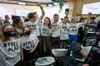 FILE - A group of protesters wear T-shirts with #FREEALAA after a panel with Sanaa Seif, sister of Egypt's jailed leading pro-democracy activist Alaa Abdel-Fattah, who is on a hunger and water strike, at the COP27 U.N. Climate Summit, Tuesday, Nov. 8, 2022, in Sharm el-Sheikh, Egypt. (AP Photo/Nariman El-Mofty, File)