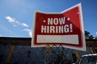 FILE PHOTO: A "now hiring" sign is displayed outside Taylor Party and Equipment Rentals in Somerville, Massachusetts, U.S., September 1, 2022. REUTERS/Brian Snyder/File Photo