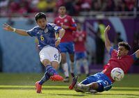 Costa Rica's Yeltsin Tejeda, right, tries to block a shot from Japan's Wataru Endo during the World Cup, group E soccer match between Japan and Costa Rica, at the Ahmad Bin Ali Stadium in Al Rayyan , Qatar, Sunday, Nov. 27, 2022. (AP Photo/Ariel Schalit)