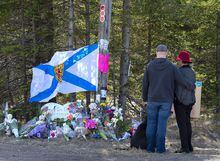 A couple pays their respects at a roadblock in Portapique, N.S. on Wednesday, April 22, 2020.&nbsp;Nova Scotia Premier Tim Houston is asking people to pause for a moment of silence today at noon and again on Wednesday to remember the 22 people killed three years ago during the worst mass shooting in Canadian history. THE CANADIAN PRESS/Andrew Vaughan