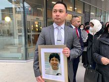 Edward Balaquit holds a picture of his father Eduardo Balaquit outside the Winnipeg Law Courts after a sentencing hearing for Kyle Pietz on Wednesday Nov. 9, 2022. Pietz was found guilty of manslaughter in the death and disappearance of Balaquit.  THE CANADIAN PRESS/Brittany Hobson