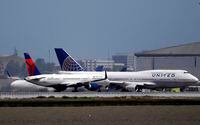 FILE - This July 11, 2017, file photo, shows a Delta Air Lines jet and a United Airlines plane at San Francisco International Airport in San Francisco. The Trump administration said Friday, June 5, 2020, it will let Chinese airlines operate a limited number of flights to the U.S., backing down from a threat to ban the flights. The decision came one day after China appeared to open the door to U.S. carriers United Airlines and Delta Air Lines resuming one flight per week each into the country. (AP Photo/Marcio Jose Sanchez, File)